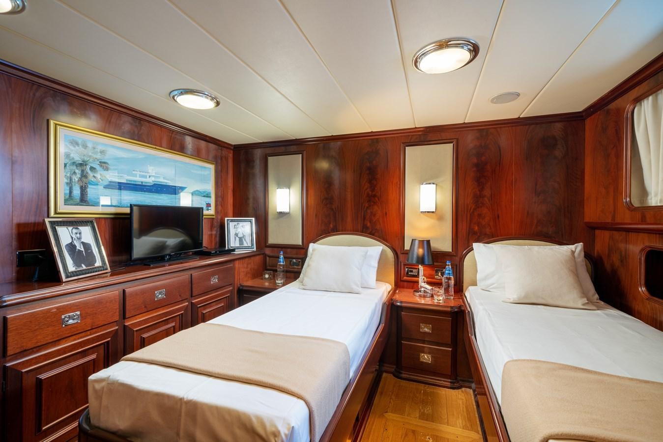 a room with a couple of beds aboard AQUARIUS IV Yacht for Sale