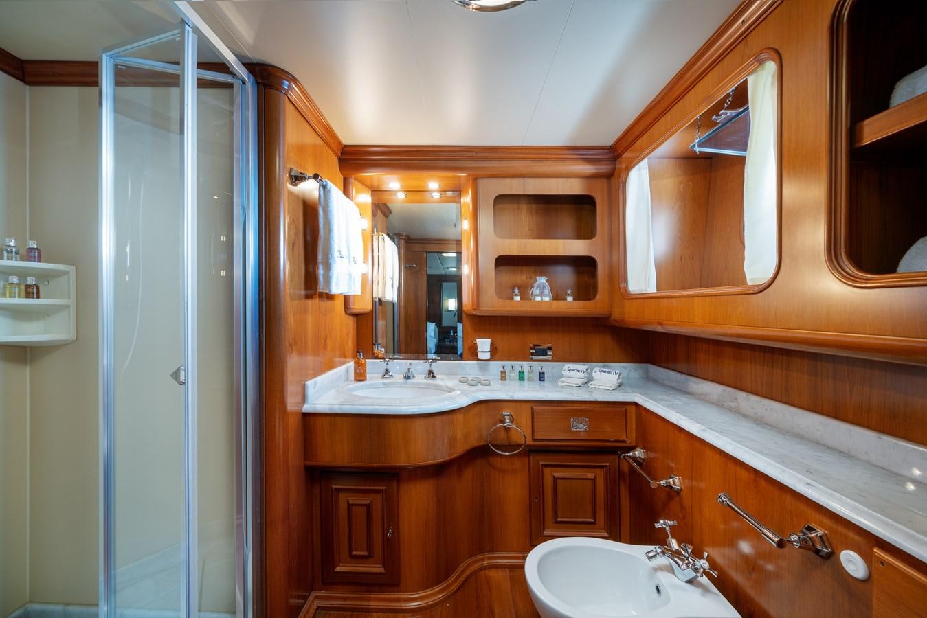 a bathroom with a sink and a mirror aboard AQUARIUS IV Yacht for Sale