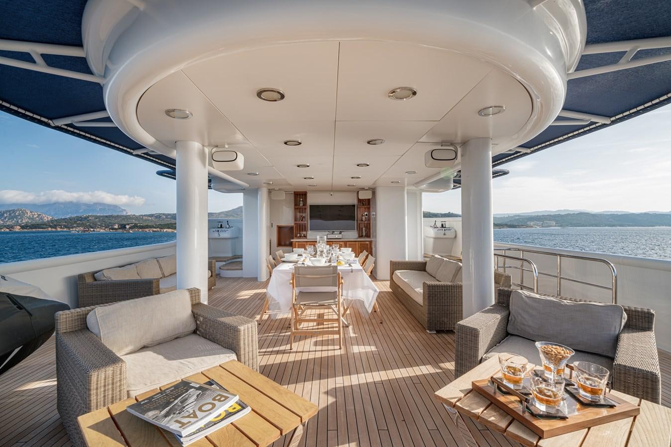 a large living room with a large balcony overlooking the ocean aboard AQUARIUS IV Yacht for Sale