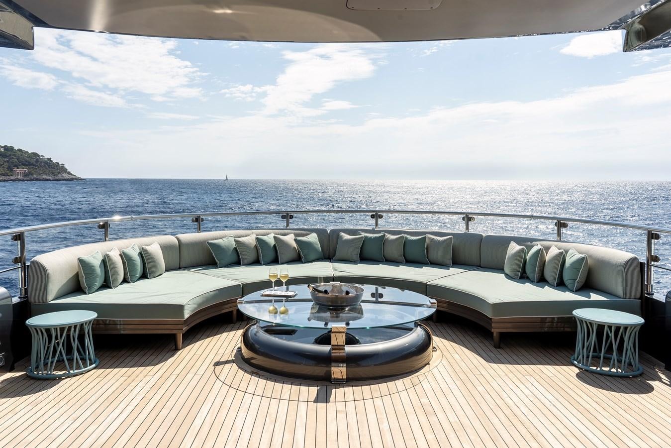 a couch and a table on a deck overlooking a body of water aboard MRS L Yacht for Sale