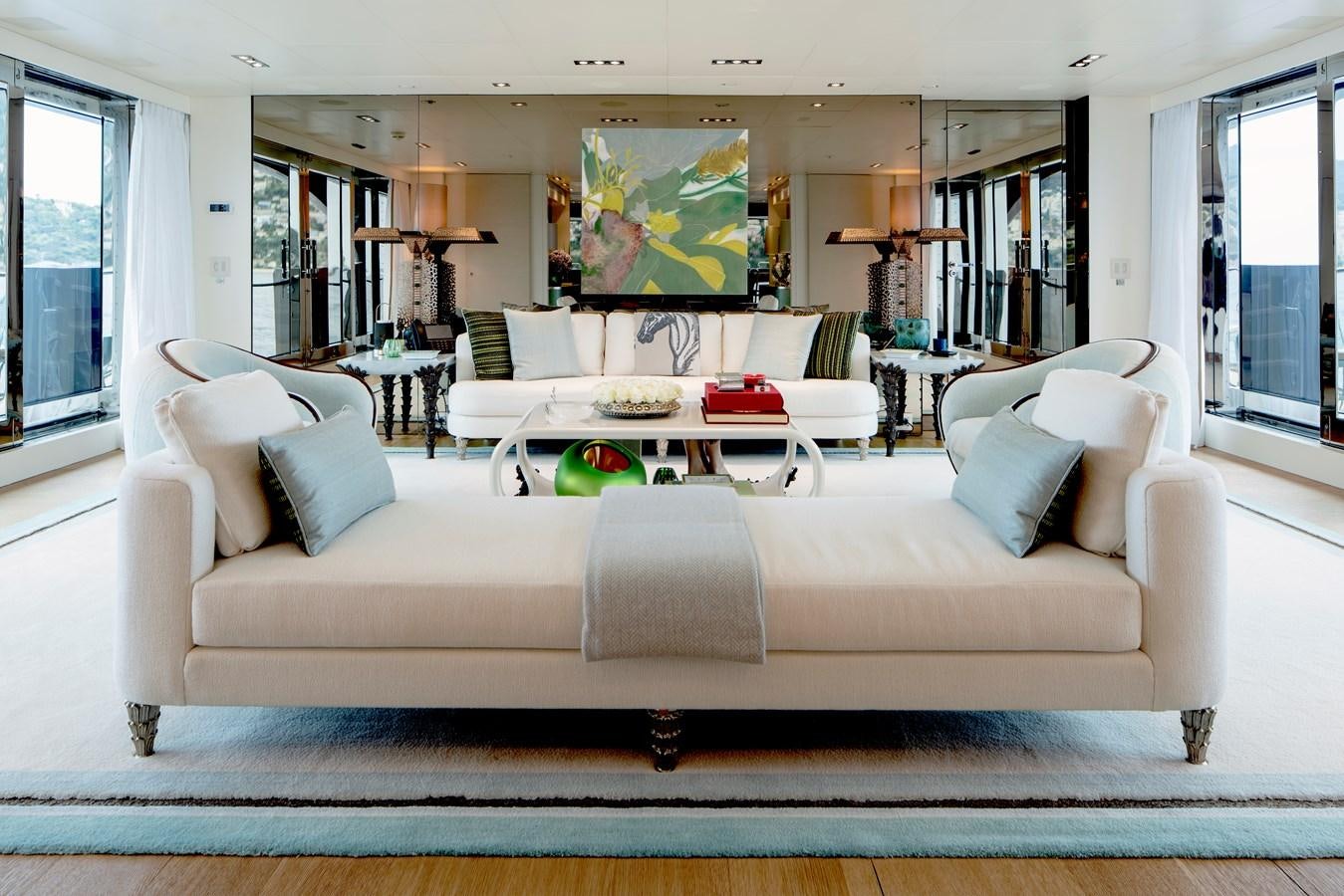 a living room with a couch and a table aboard MRS L Yacht for Sale