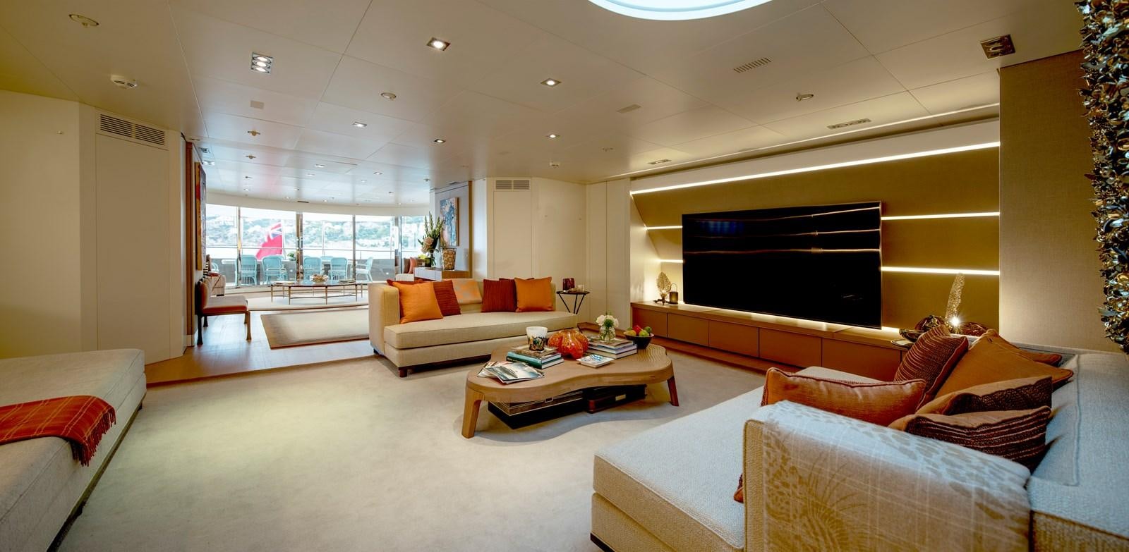 a living room with a large screen aboard MRS L Yacht for Sale