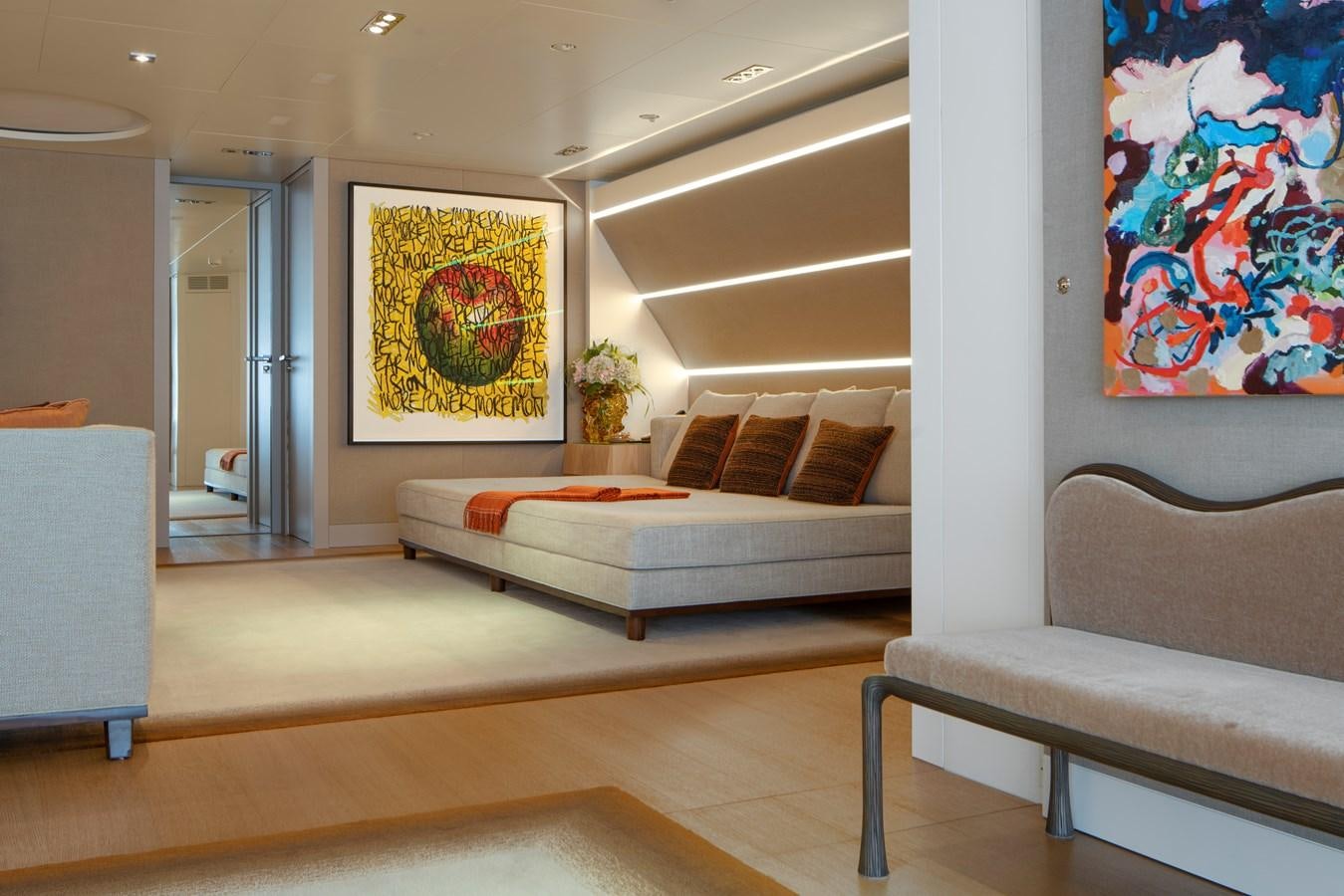 a living room with a couch and a painting on the wall aboard MRS L Yacht for Sale