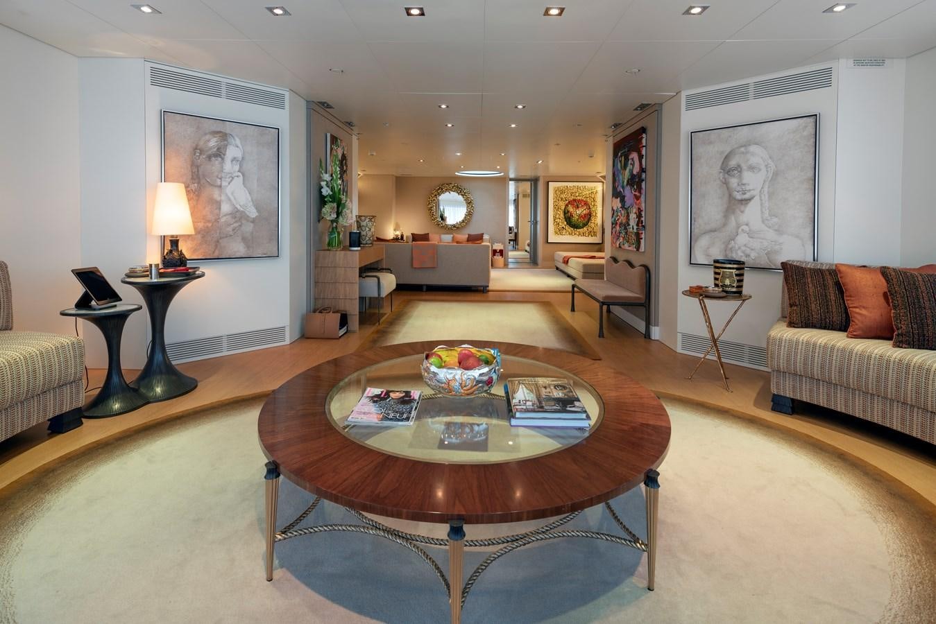a living room with a table and couches aboard MRS L Yacht for Sale