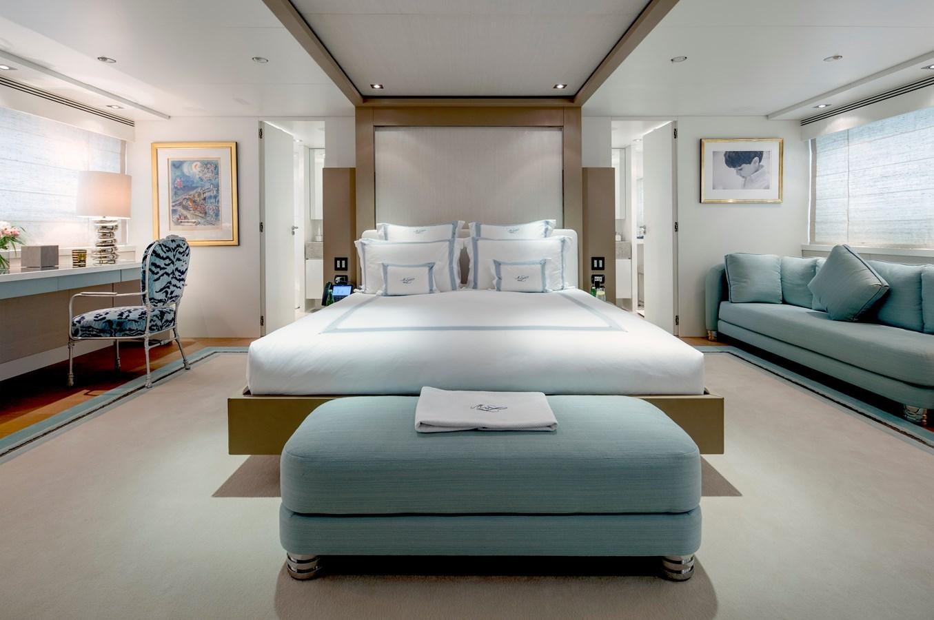 a large bedroom with a bed and a couch aboard MRS L Yacht for Sale