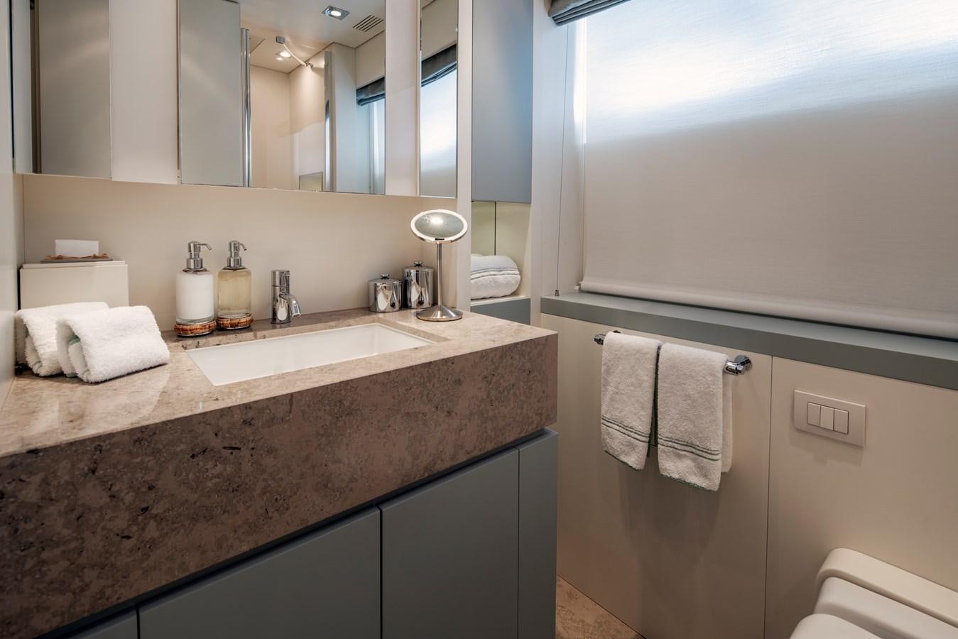 a bathroom with a countertop sink and mirror aboard MRS L Yacht for Sale