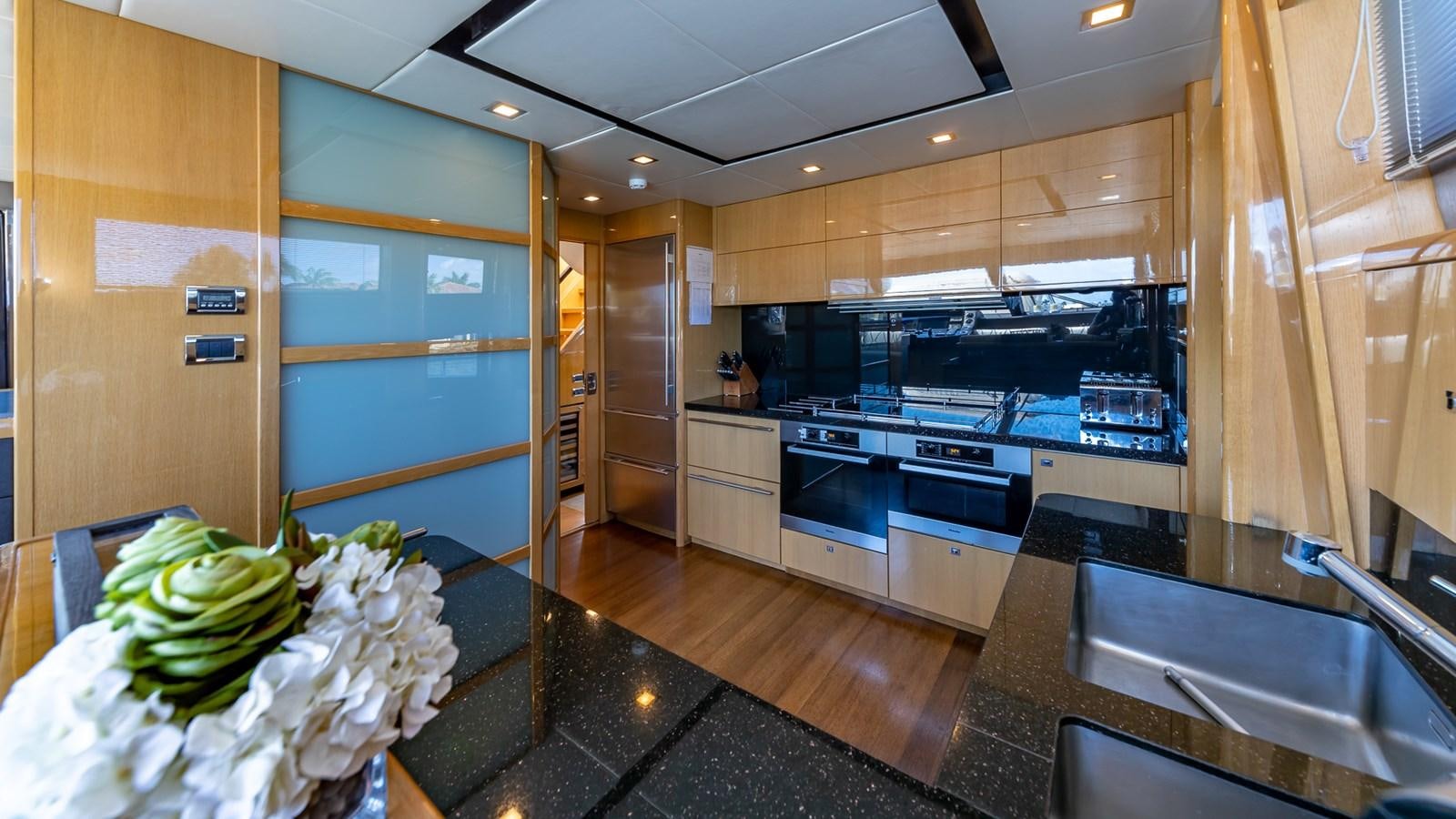 a kitchen with a countertop sink and cabinets aboard BELLA RONA Yacht for Sale