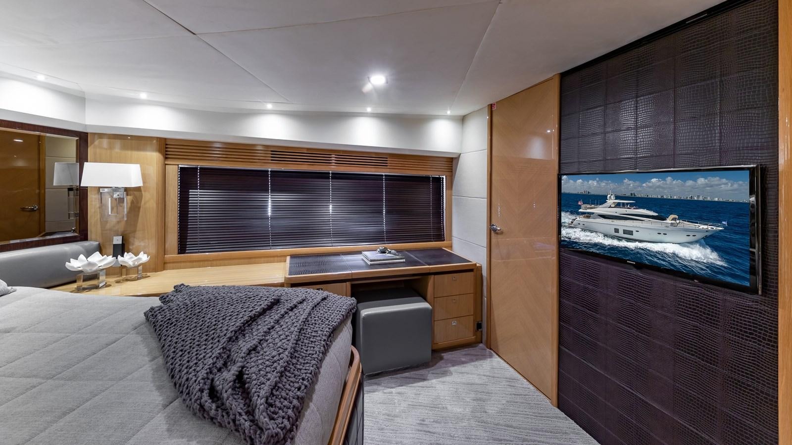 a room with a bed and a tv on the wall aboard BELLA RONA Yacht for Sale