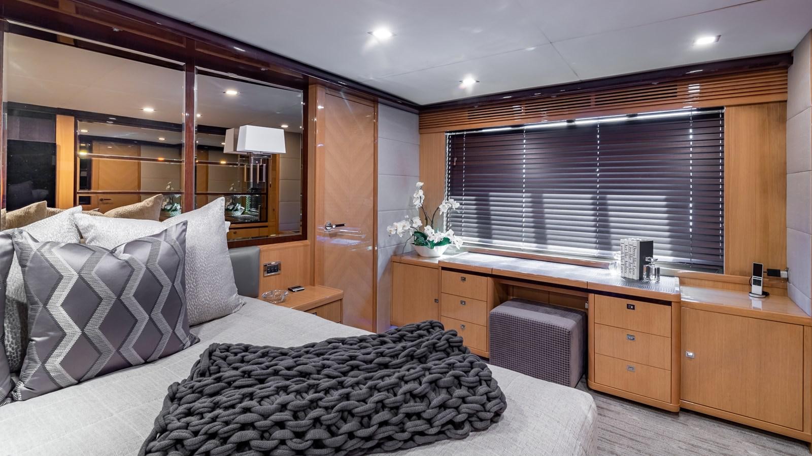a bedroom with a bed and desk aboard BELLA RONA Yacht for Sale