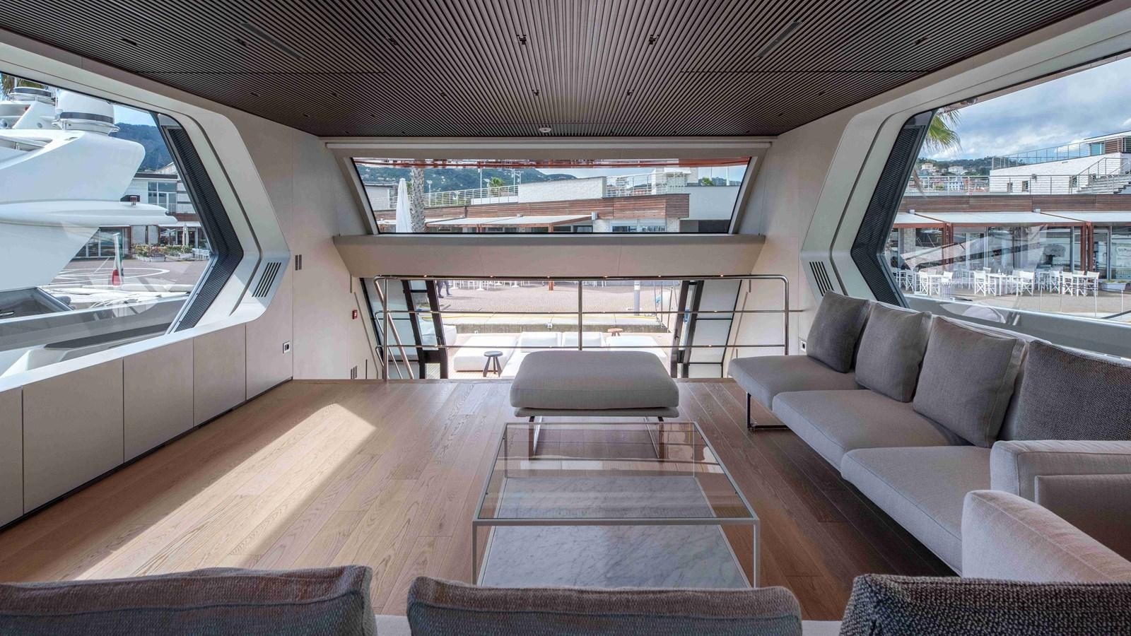 a large room with couches aboard SP110-03 Yacht for Sale