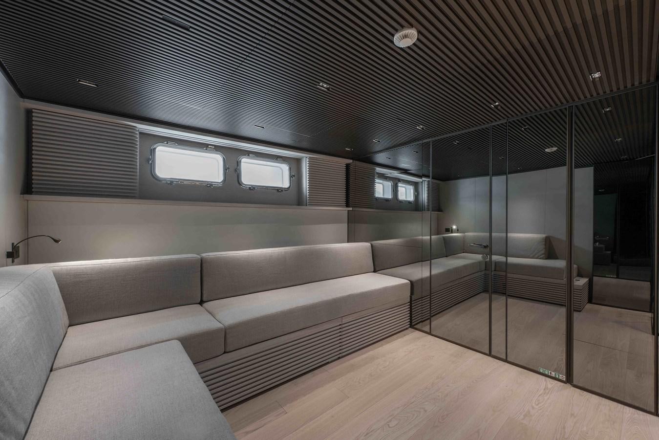 a room with a couch and a glass door aboard SP110-03 Yacht for Sale