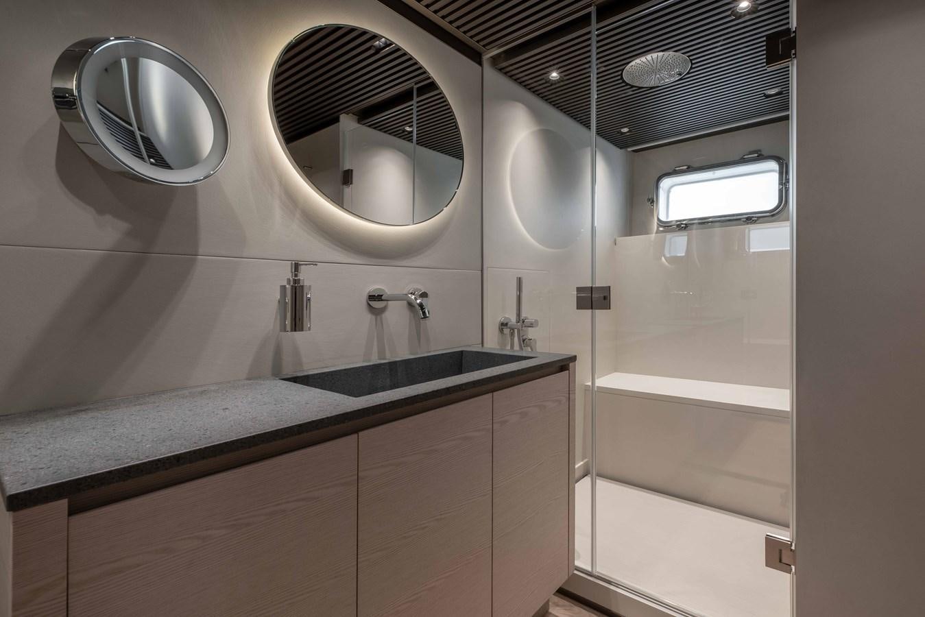 a bathroom with a large mirror aboard SP110-03 Yacht for Sale
