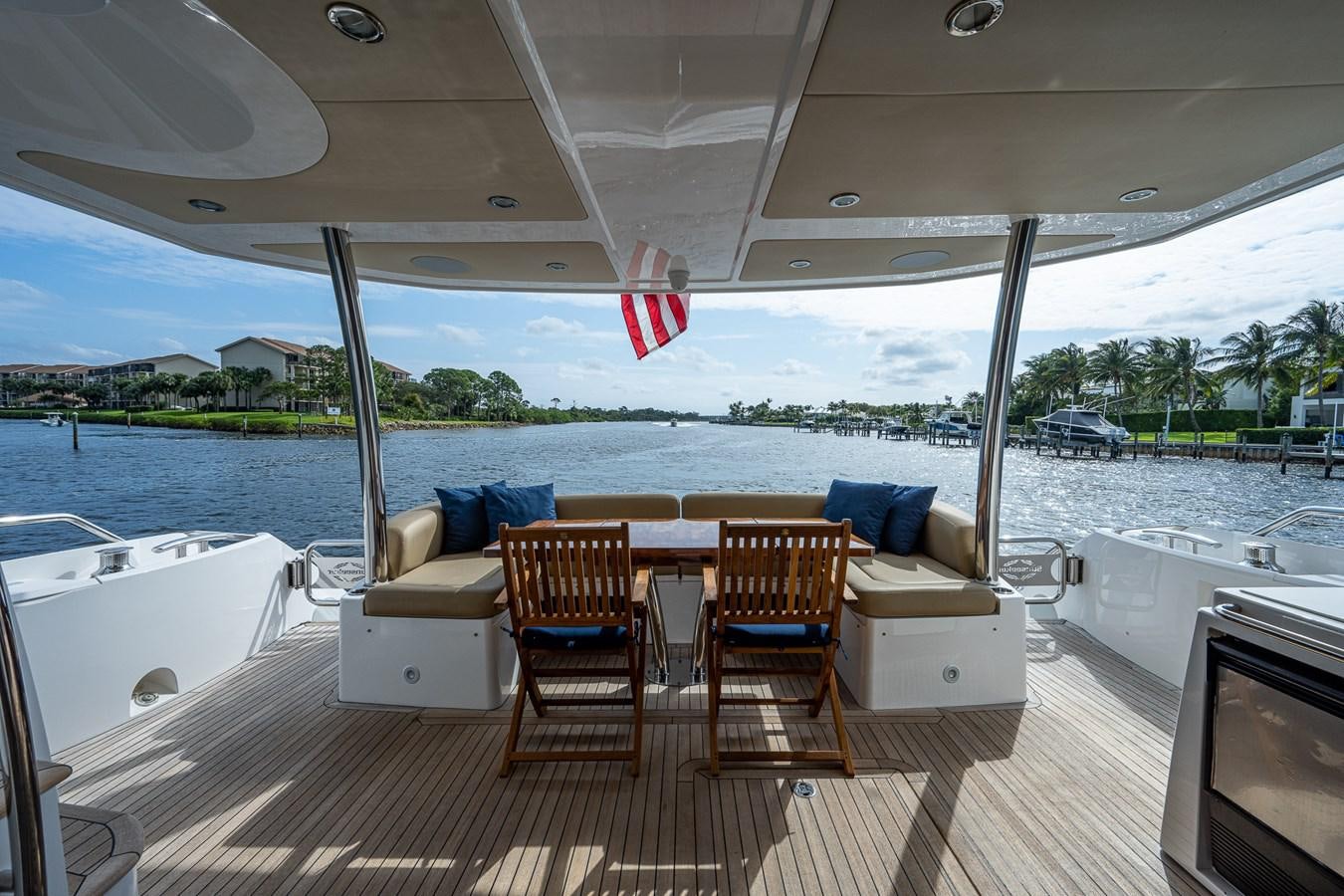 a boat with a table and chairs on a deck aboard 212 Yacht for Sale