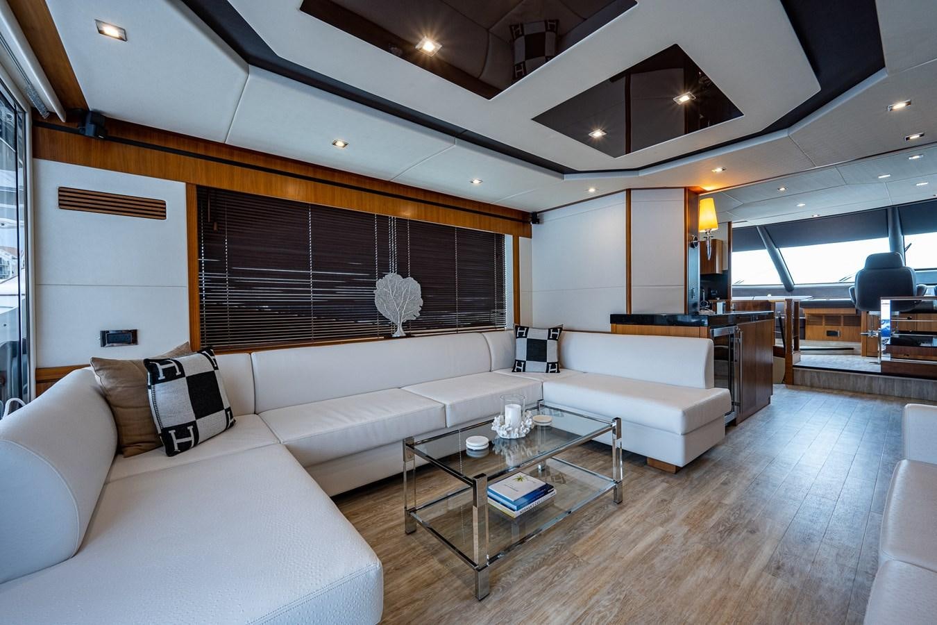 a living room with white couches aboard 212 Yacht for Sale