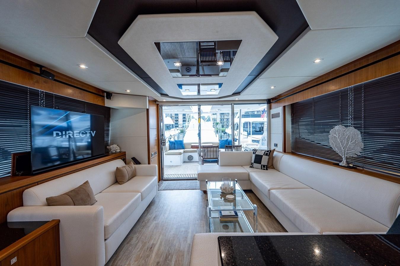 a living room with a large screen aboard 212 Yacht for Sale