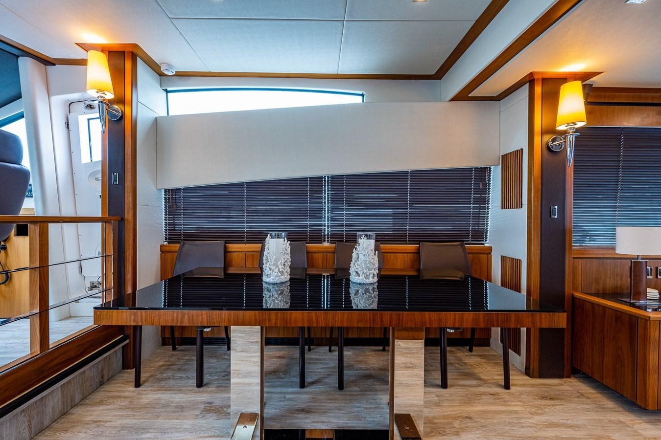 a room with a table and chairs aboard 212 Yacht for Sale