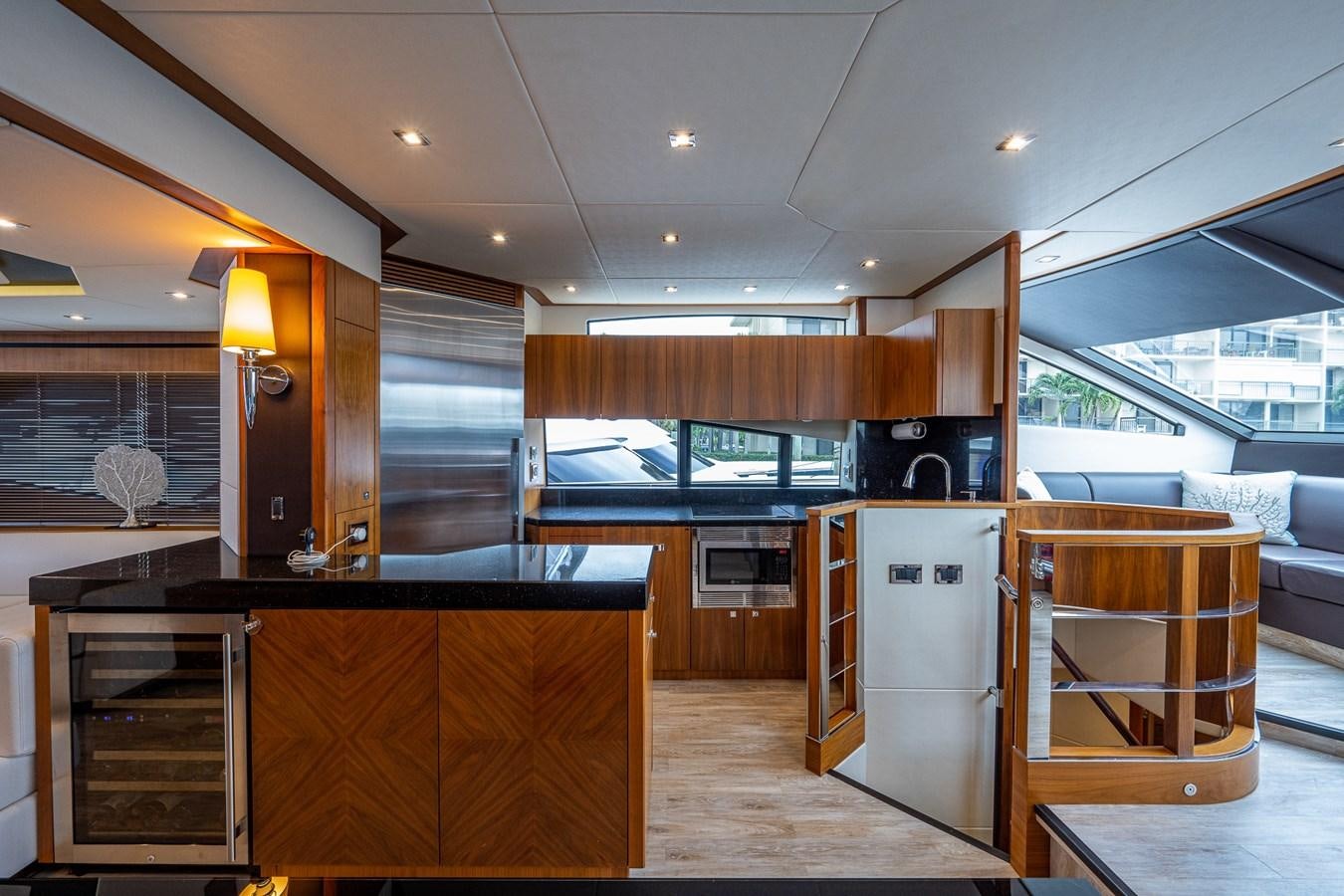 a kitchen with wooden cabinets aboard 212 Yacht for Sale