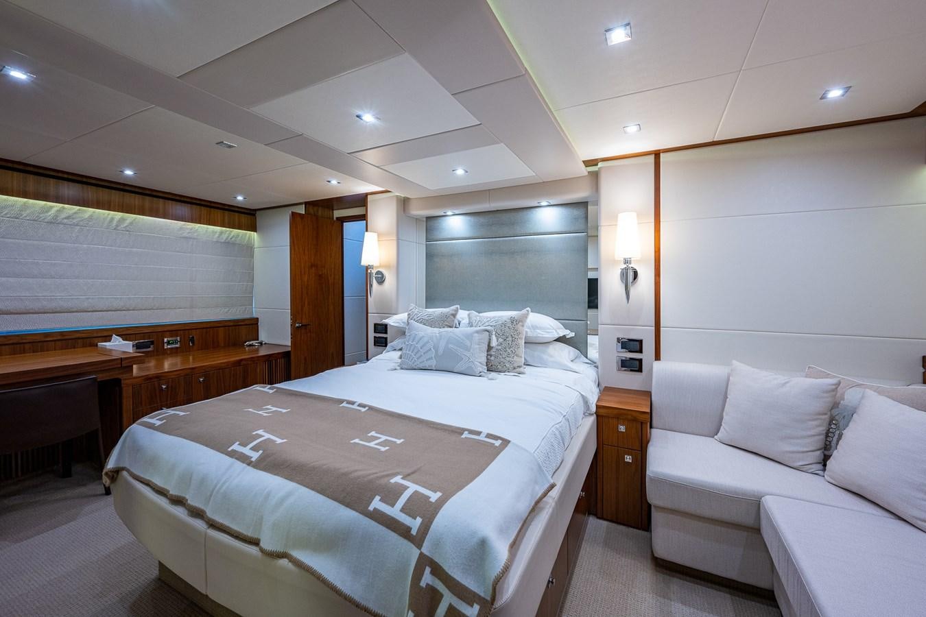 a hotel room with a bed and a desk aboard 212 Yacht for Sale