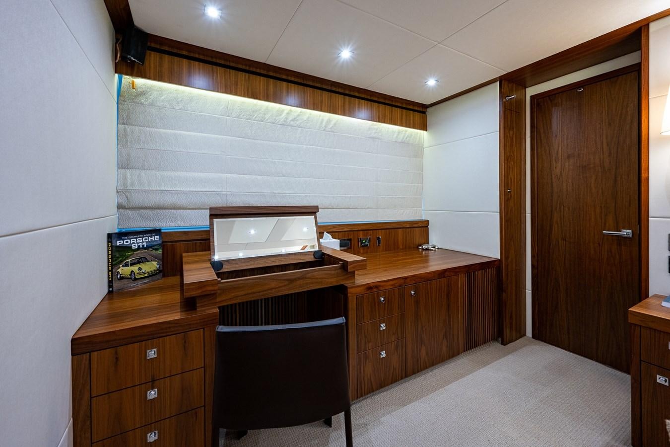 a room with a desk and a laptop on a chair aboard 212 Yacht for Sale