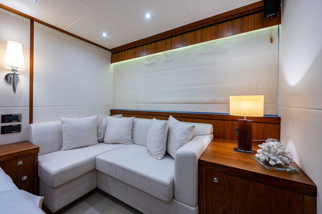 a white couch in a room aboard 212 Yacht for Sale