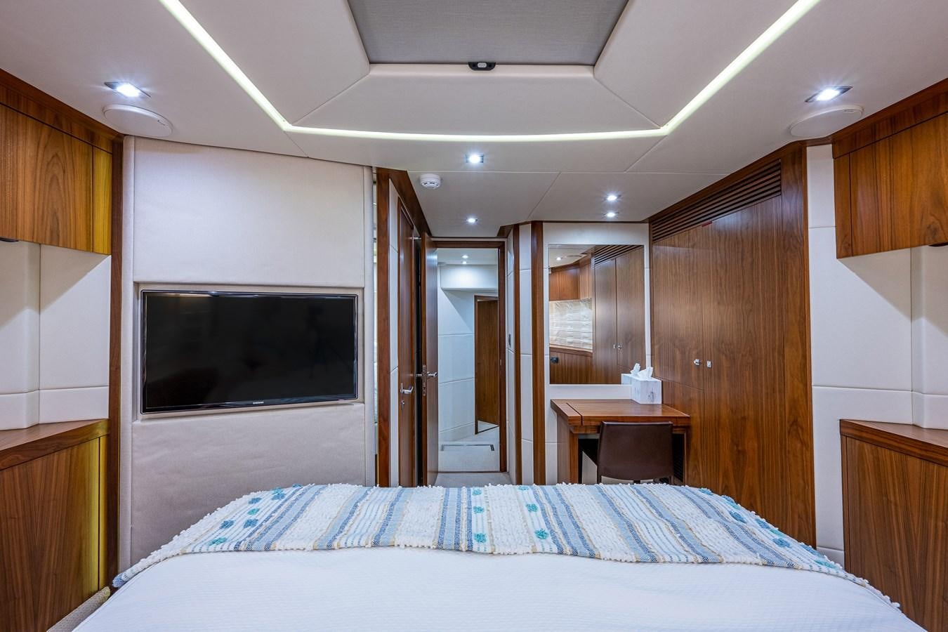 a bedroom with a bed and a television aboard 212 Yacht for Sale