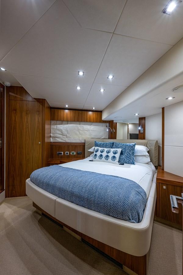 a room with a bed and a wood door aboard 212 Yacht for Sale