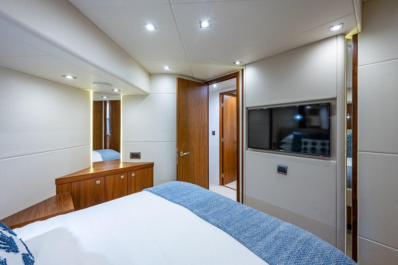 a bedroom with a bed and a television aboard 212 Yacht for Sale
