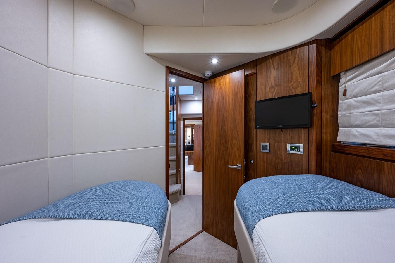 a room with a bed and a television aboard 212 Yacht for Sale