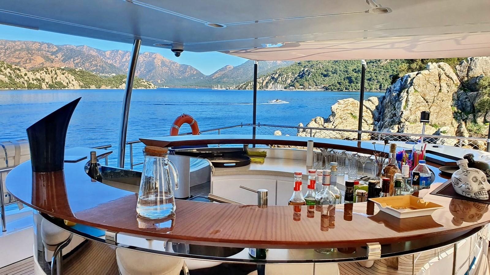 a table with bottles and glasses on it aboard GOLDEN LIFE Yacht for Sale