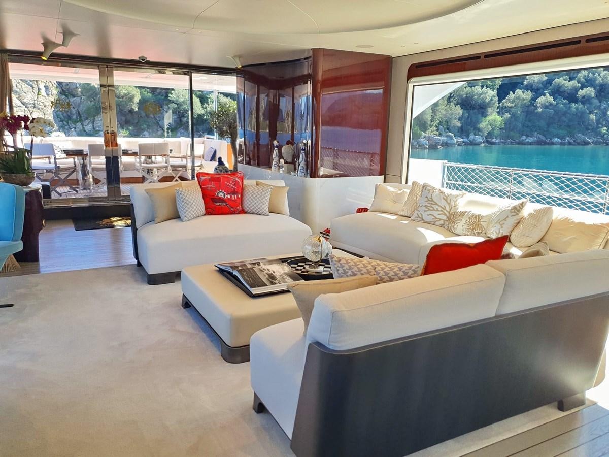 a living room with white couches and a table aboard GOLDEN LIFE Yacht for Sale