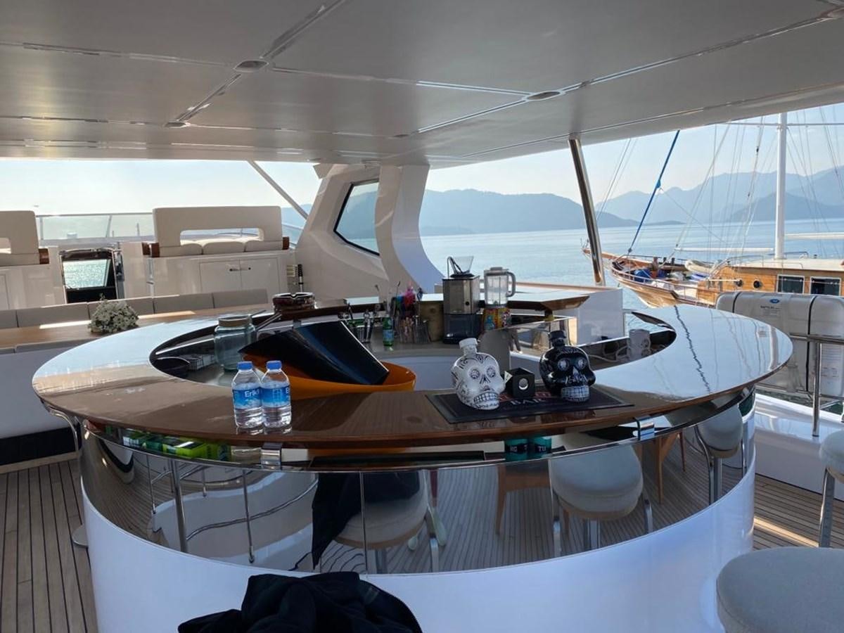 a room with a table and chairs aboard GOLDEN LIFE Yacht for Sale