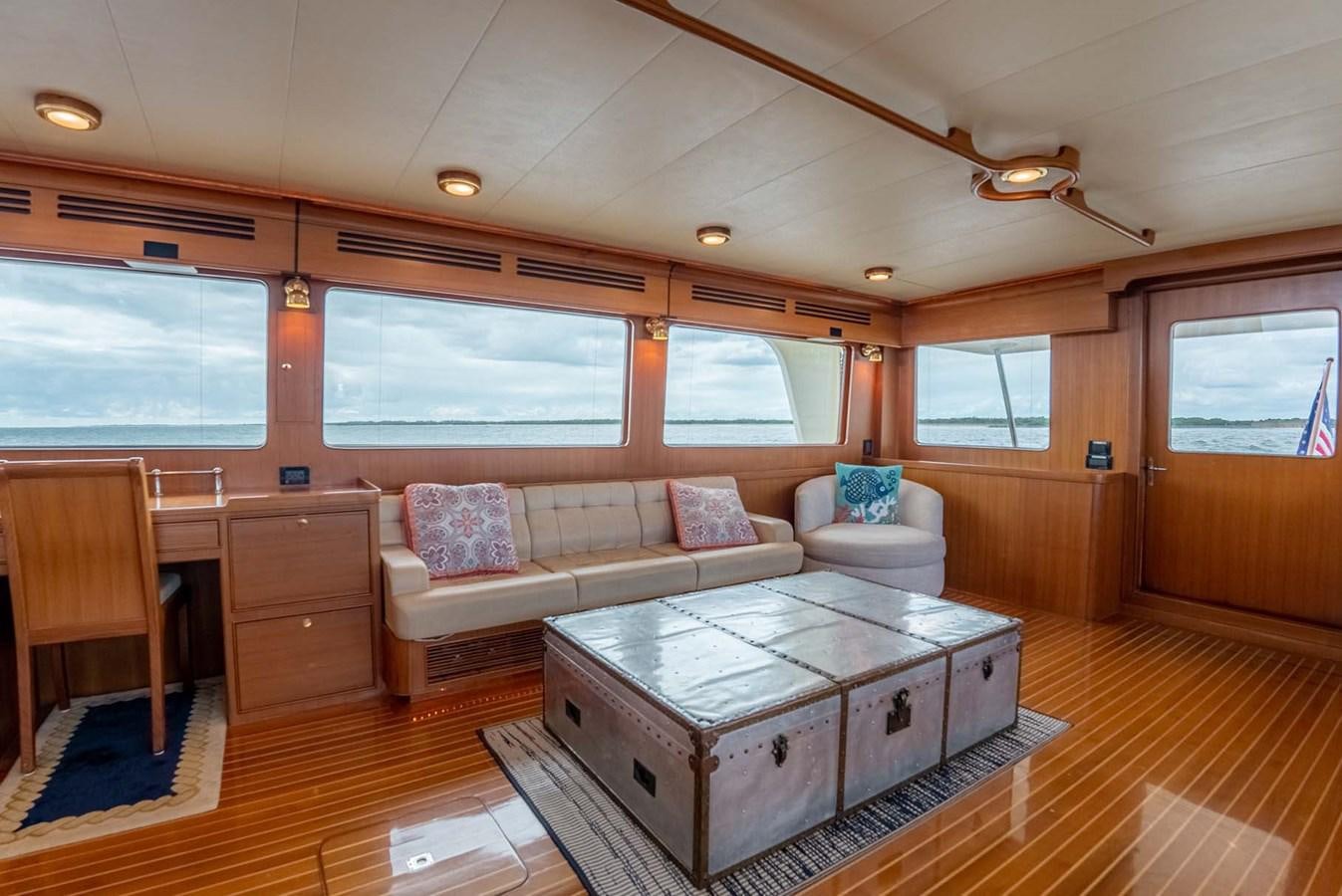 a living room with a couch and a table aboard SOMEDAY CAME Yacht for Sale