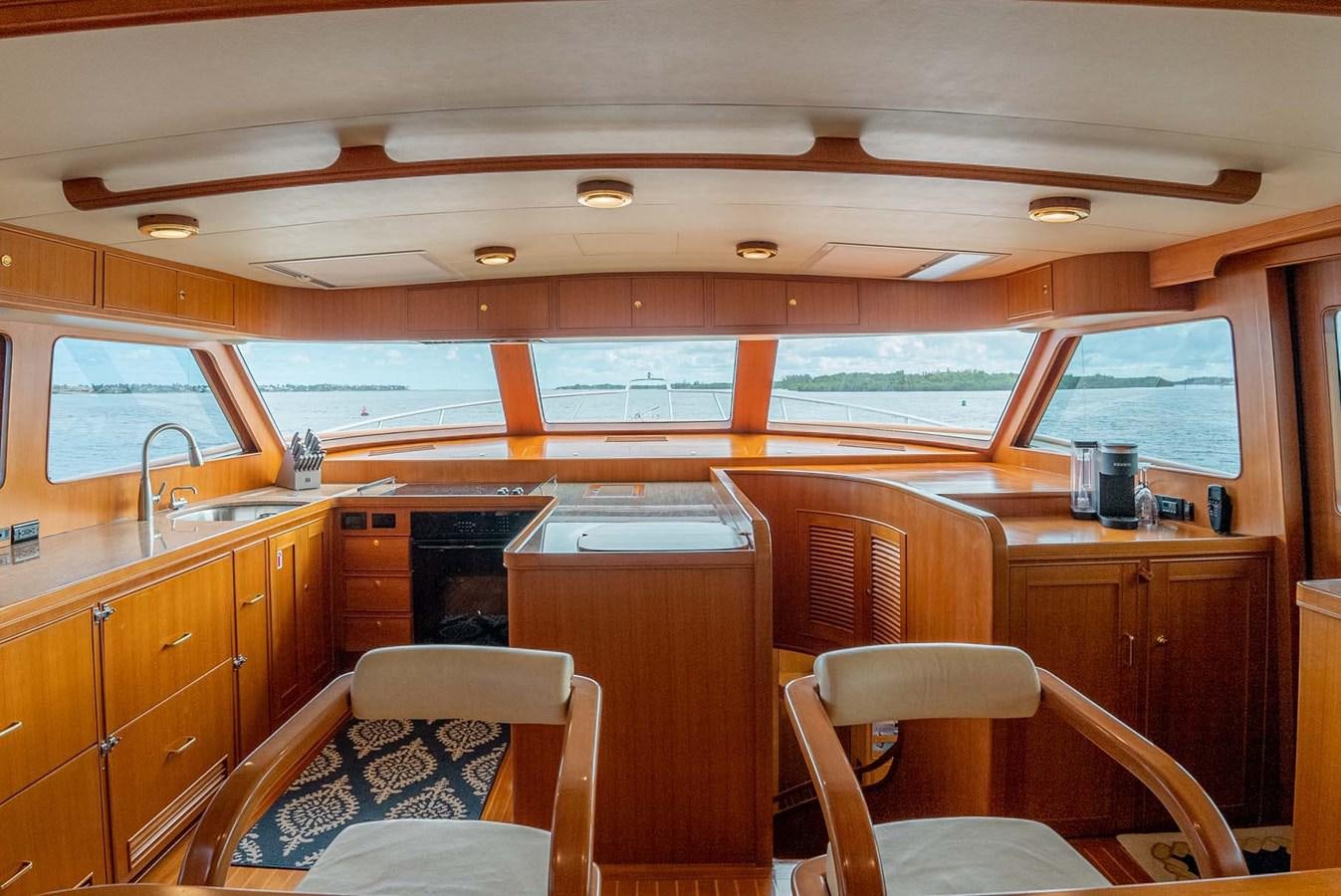 a kitchen with wooden cabinets aboard SOMEDAY CAME Yacht for Sale