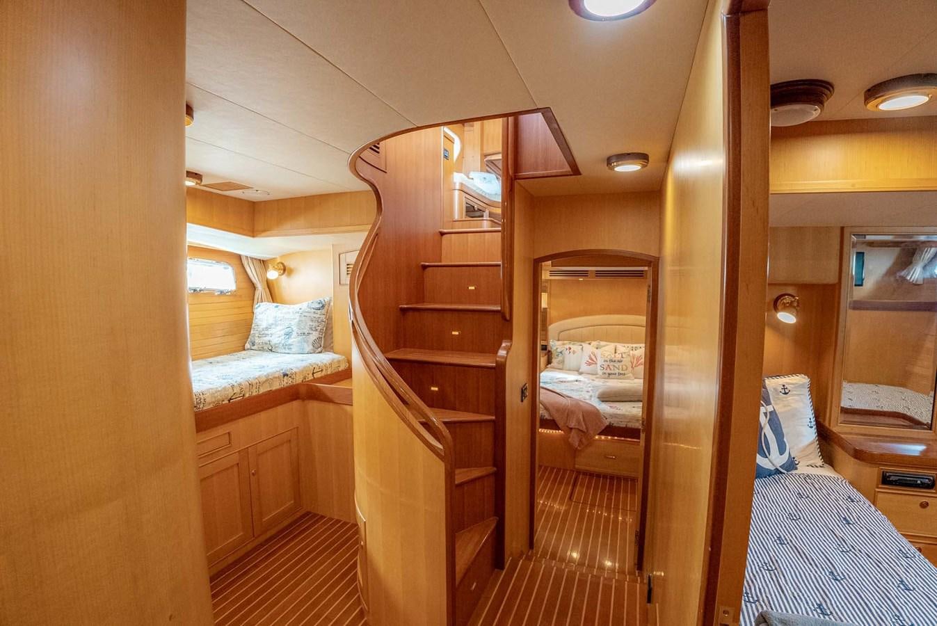 a room with a bunk bed and a wood door aboard SOMEDAY CAME Yacht for Sale