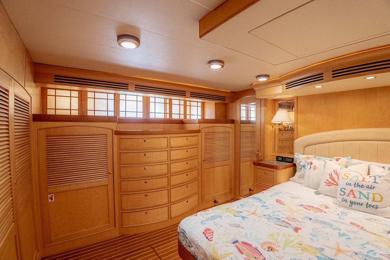a bedroom with a bed and a dresser aboard SOMEDAY CAME Yacht for Sale