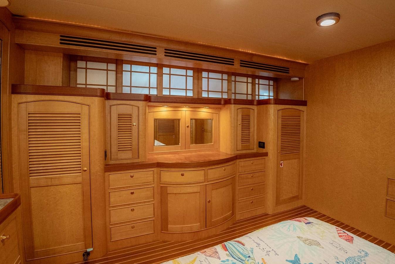 a bedroom with a bed and cabinets aboard SOMEDAY CAME Yacht for Sale