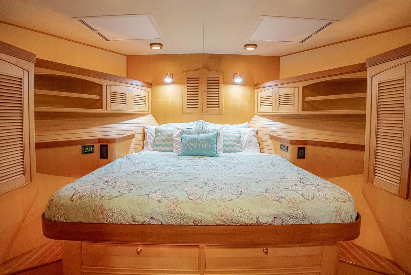 a bed with a wood headboard aboard SOMEDAY CAME Yacht for Sale