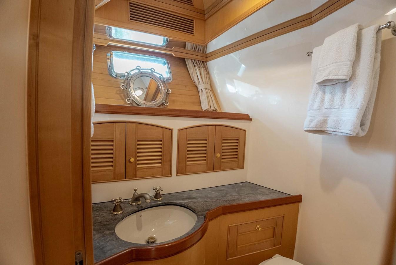 a bathroom with a sink and a mirror aboard SOMEDAY CAME Yacht for Sale
