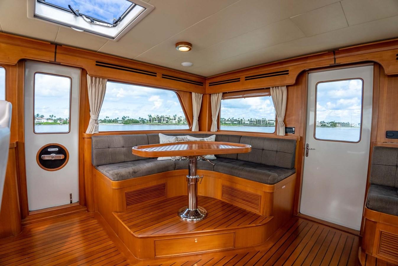 a room with a piano and a window aboard SOMEDAY CAME Yacht for Sale