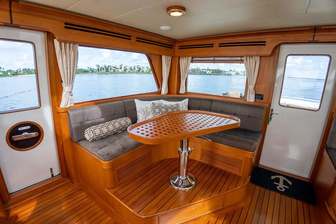 a living room with a couch and a table aboard SOMEDAY CAME Yacht for Sale