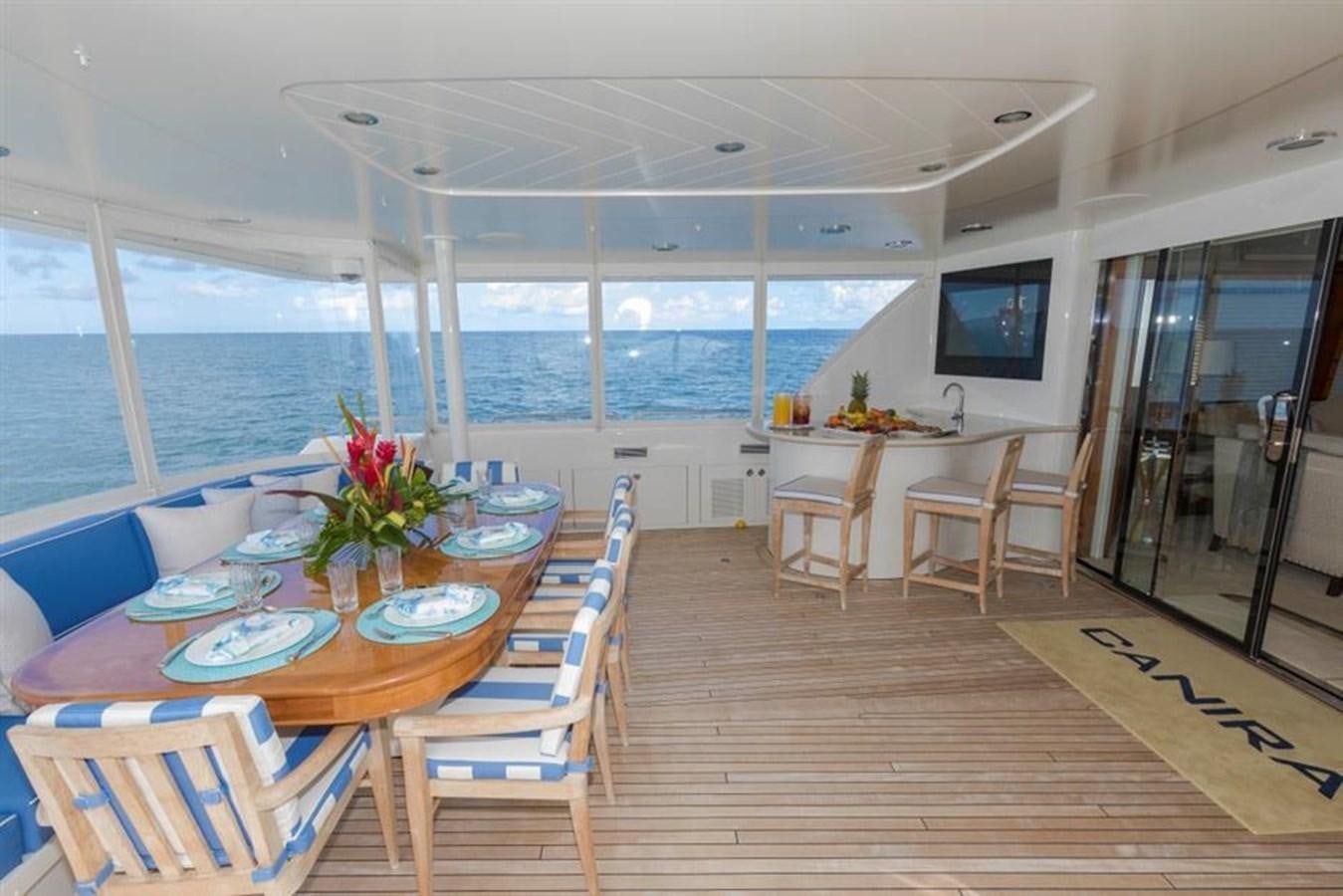 a room with a table and chairs aboard NO NAME 112 Yacht for Sale