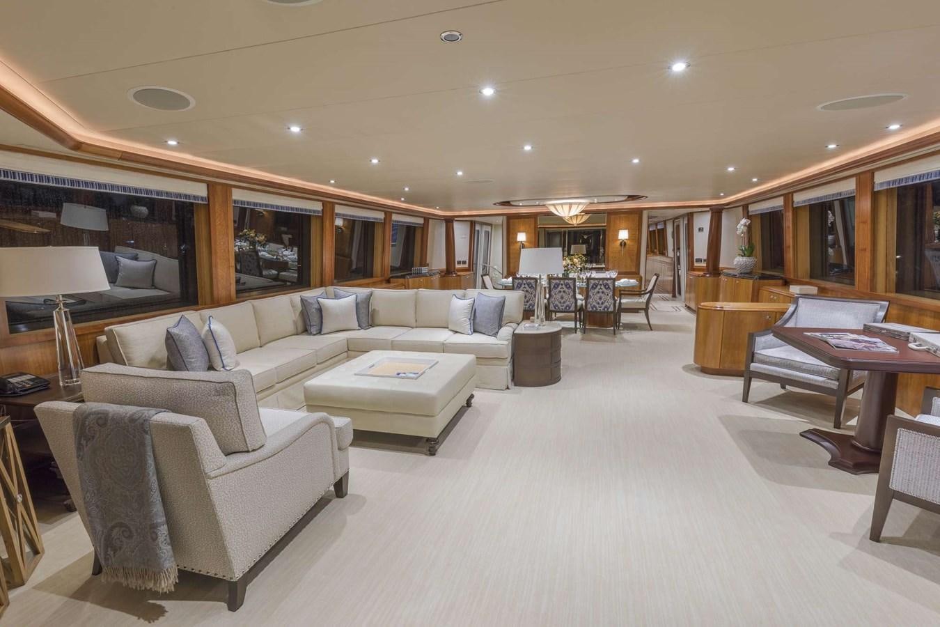 a living room with a large white couch and a table aboard NO NAME 112 Yacht for Sale