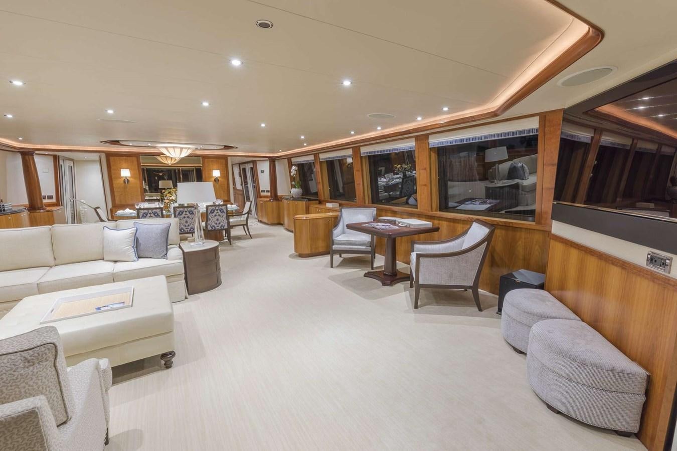 a living room with a large white sofa and a table aboard NO NAME 112 Yacht for Sale