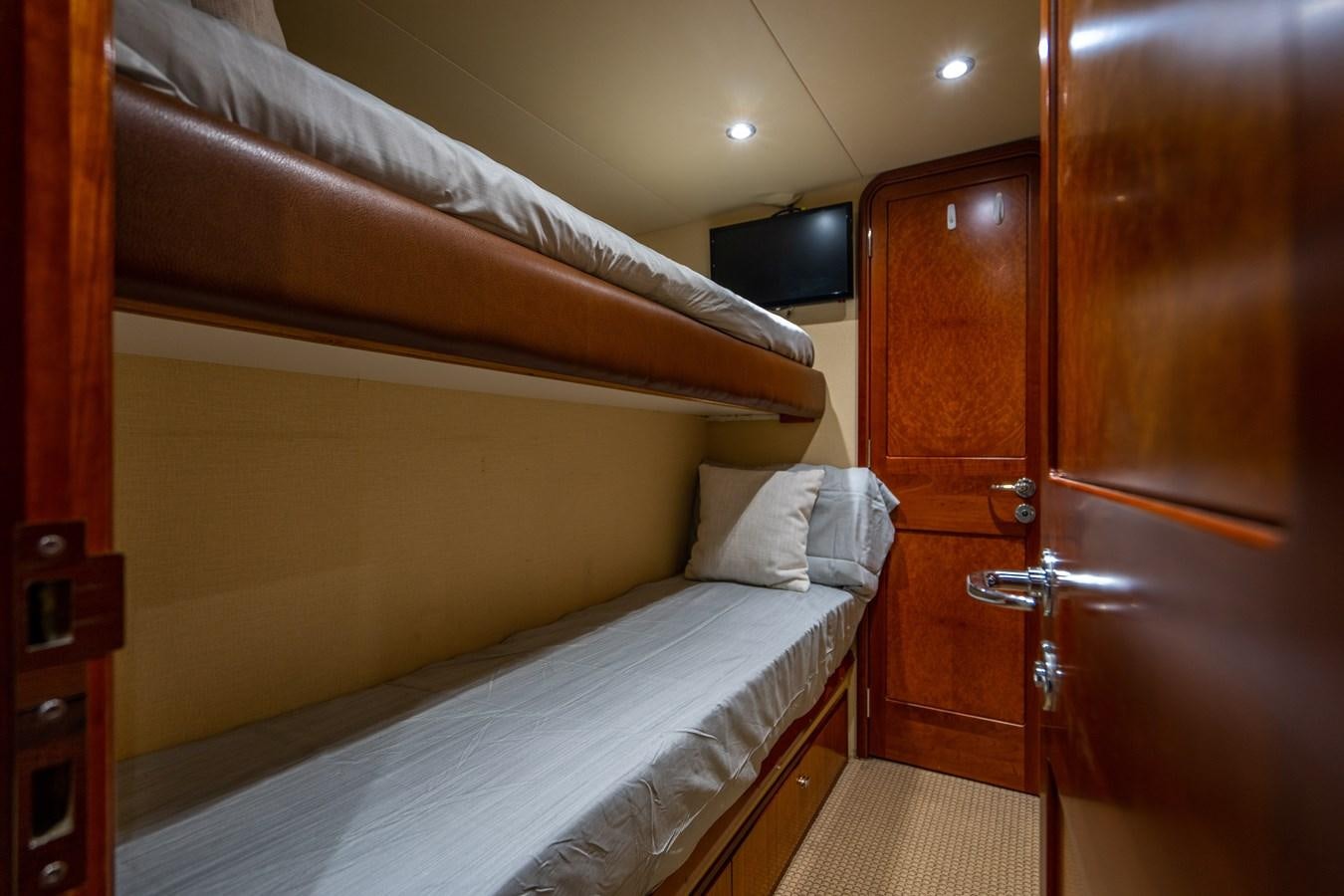a room with a bed and a television aboard NO NAME 112 Yacht for Sale