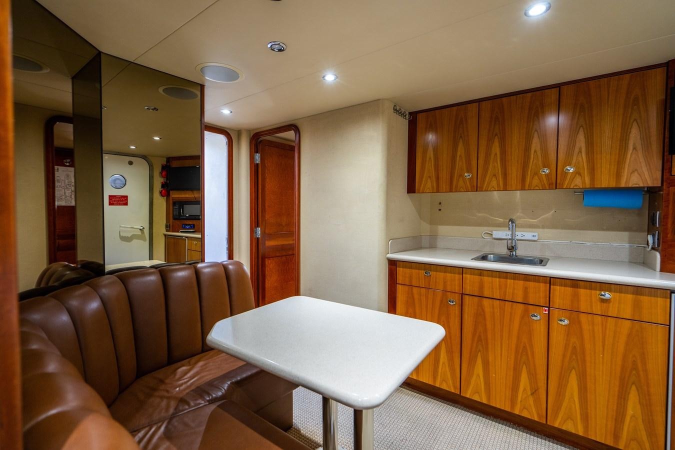 a living room with a couch and a table aboard NO NAME 112 Yacht for Sale