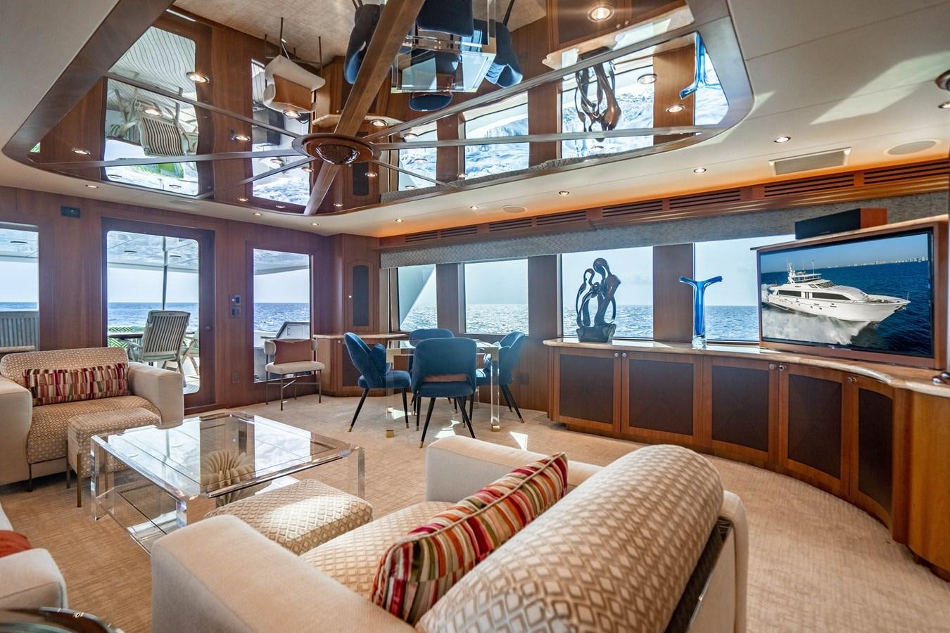 a room with a couch and a table and chairs aboard INEVITABLE Yacht for Sale