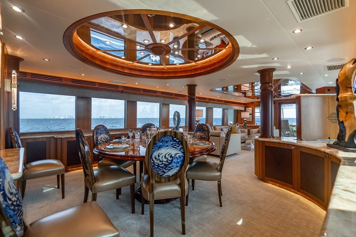 a large room with a table and chairs aboard INEVITABLE Yacht for Sale