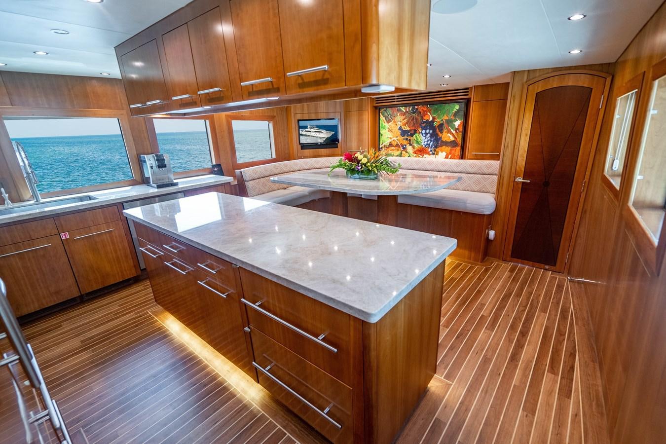 a kitchen with wooden cabinets aboard INEVITABLE Yacht for Sale