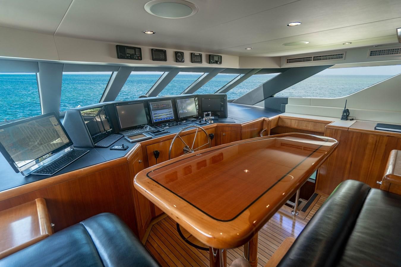 a room with a table and chairs aboard INEVITABLE Yacht for Sale