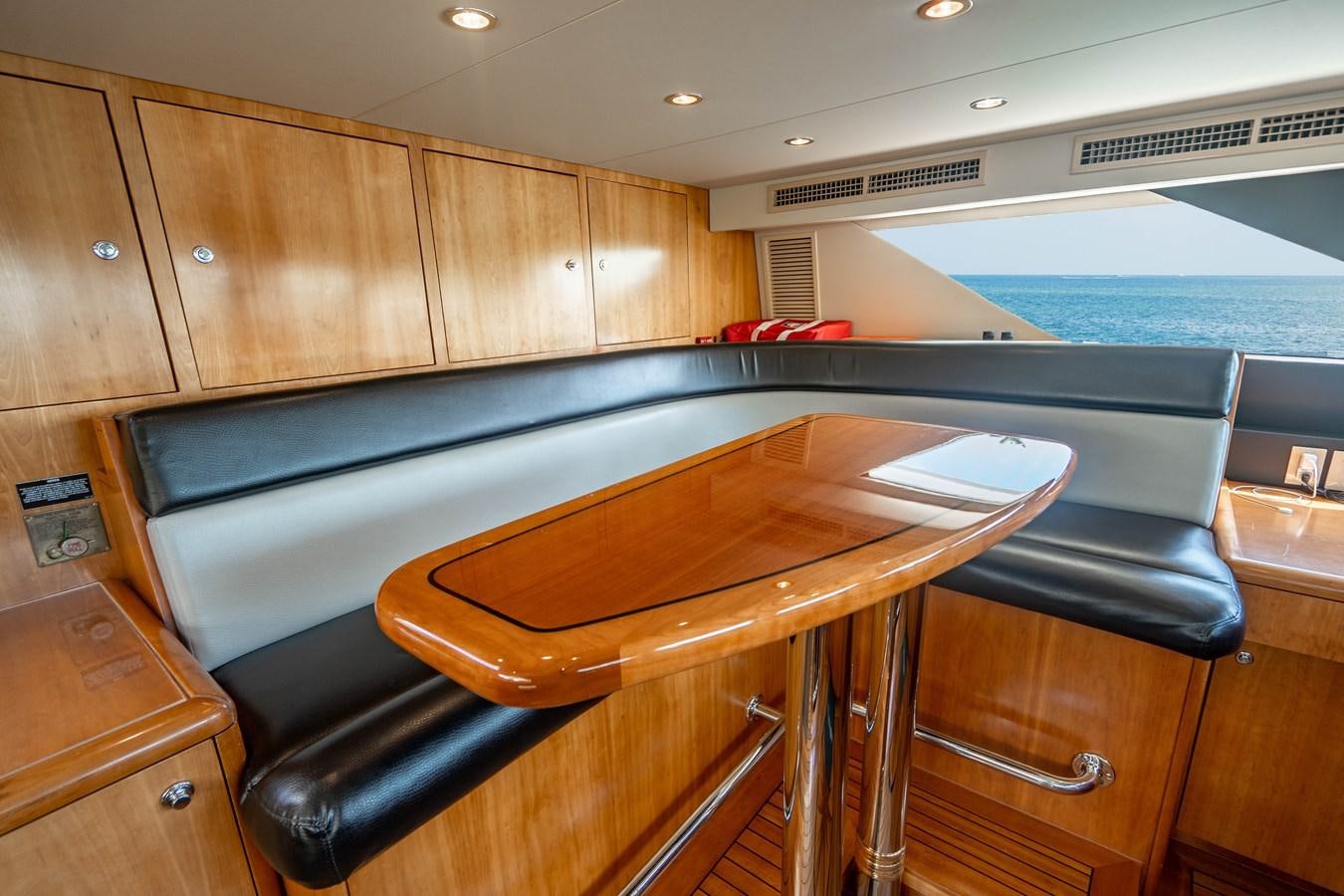 a kitchen with a table and chairs aboard INEVITABLE Yacht for Sale